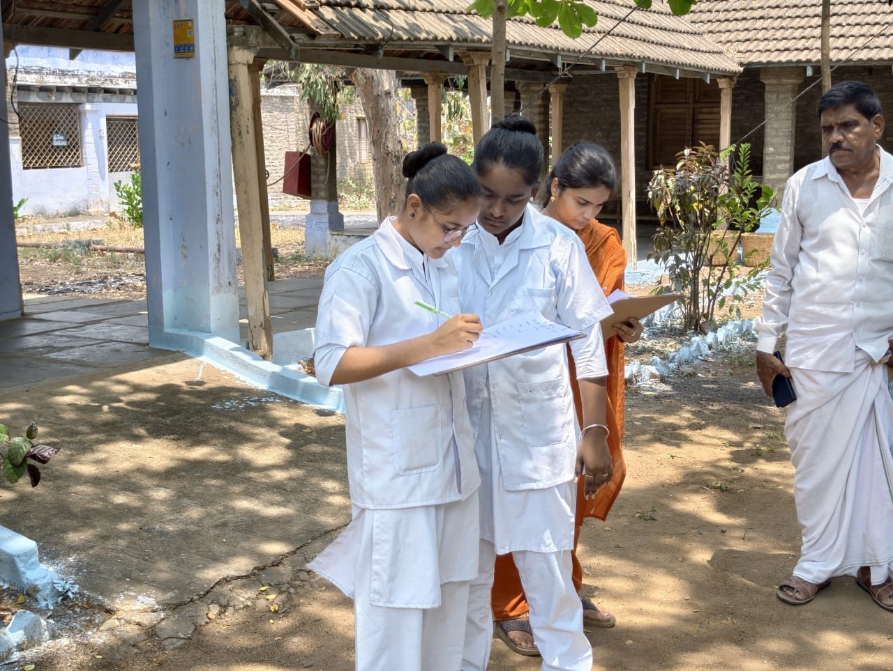 Nursing students recording patient details